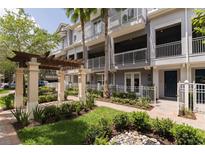 Beautiful exterior of a three story townhome with well-manicured landscaping and small water feature at 1767 Piedmont Pl, Lake Mary, FL 32746