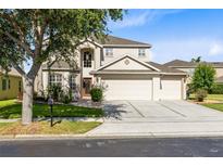 Charming two-story home featuring a spacious three-car garage and well-manicured landscaping at 2704 Gorst Rd, Winter Garden, FL 34787