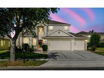 Charming two-story home with a three car garage and well-manicured lawn and landscaping at 2704 Gorst Rd, Winter Garden, FL 34787