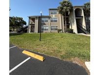 A charming condo building with well-maintained landscaping and convenient parking at 4772 Walden Cir # 228, Orlando, FL 32811