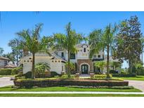 Elegant two-story home with lush landscaping and well-manicured lawn, offering great curb appeal at 5550 Osprey Isle Ln, Orlando, FL 32819