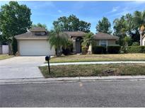 Charming single-story home with a well-manicured front yard and attached two-car garage at 840 Lake Jackson Cir, Apopka, FL 32703