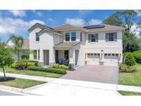 Charming two-story home boasts a manicured lawn, symmetrical design, and a convenient two-car garage at 8768 Sonoma Coast Dr, Winter Garden, FL 34787