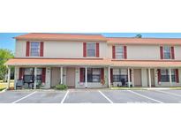 Charming condo featuring red shutters and a well-maintained exterior with convenient guest parking spaces at 980 Canal View Blvd # N2, Port Orange, FL 32129