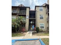 Condominium building featuring stairs leading to upper units, tropical landscaping, and accessible entrance at 208 Afton Sq # 307, Altamonte Springs, FL 32714