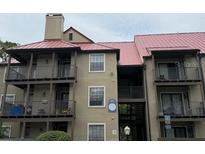 Multi-story condo building with red metal roof and private balconies on each level at 224 Afton Sq # 301, Altamonte Springs, FL 32714