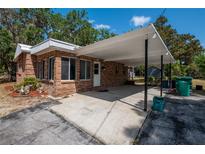 Brick home with a covered front entrance and driveway at 237 W Mcclendon St, Lady Lake, FL 32159