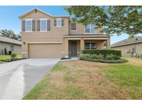 Charming two-story home featuring a two-car garage, neutral paint, manicured landscaping, and a welcoming front porch at 3443 Berkshire Woods Ter, Deltona, FL 32725