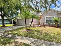 Charming home with a two-car garage, well-manicured lawn, and tasteful landscaping at 3579 Maple Ridge Loop, Kissimmee, FL 34741