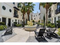 Charming courtyard with a fountain, tropical landscaping, and Adirondack chairs at 654 Mariposa St, Orlando, FL 32801