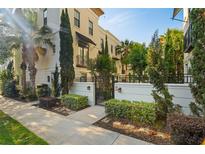 Elegant townhouse with manicured landscaping, gated entry, and modern architectural details at 654 Mariposa St, Orlando, FL 32801