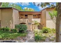 Inviting two-story condo with lush landscaping and a well-maintained walkway at 1111 Salerno Ct # Ge, Orlando, FL 32806