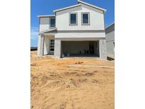 Modern two-story home featuring a spacious two-car garage and stone pillar accents at 1904 Diamond Head Cir, Lake Hamilton, FL 33851