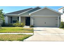 Charming single-Gathering home featuring a two-car garage and well-maintained lawn at 2000 Golden Beak Dr, Eagle Lake, FL 33839