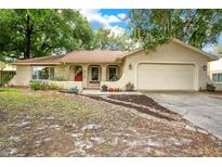 Charming single-story home featuring a well-maintained lawn and an attached two-car garage at 8316 Granada Blvd, Orlando, FL 32836