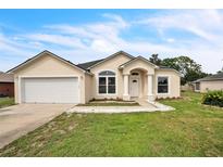 Charming single-story home featuring a well-maintained lawn, neutral colors, and an attached two-car garage at 1139 Humphrey Blvd, Deltona, FL 32738