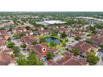 Wonderful aerial view of condo community with beautiful landscaping and central pond at 12107 Poppy Field Ln # 105, Orlando, FL 32837