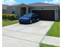 Charming single-Gathering home with a well-maintained lawn, two-car garage, and long driveway at 3582 Forster Ave, Leesburg, FL 34748