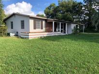 Charming single-story home with a well-maintained lawn and inviting front porch at 636 S Wellington Dr, Deltona, FL 32725