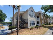 A beautiful condo building with well maintained grounds, landscaping, and stairway at 1071 S Hiawassee Rd # 1211, Orlando, FL 32835