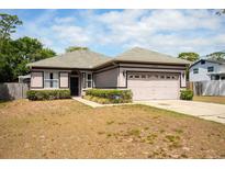 Charming single-story home featuring a well-maintained lawn, inviting entrance, and two car garage at 1718 Elaine Ave, Altamonte Springs, FL 32701