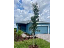 Charming single-story home with blue siding, an attached garage and a neatly landscaped front yard at 1912 Diamond Head Cir, Lake Hamilton, FL 33851