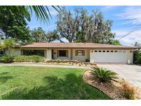 Charming one-story home with manicured lawn, mature trees and a two car garage at 195 E Faith Ter, Maitland, FL 32751
