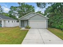 Charming single-story home featuring a well-manicured lawn and an attached two-car garage at 2618 Sidney Ave, Orlando, FL 32810