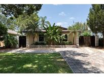Inviting front yard with lush landscaping and a charming, paved walkway leading to the home at 2711 Parkland Dr, Winter Park, FL 32789