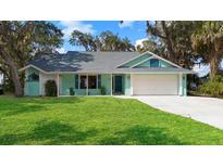 Charming home featuring a lush lawn, freshly-painted trim, and an attached two-car garage at 3385 Lake Harney Cir, Geneva, FL 32732