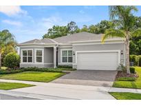 Charming single-story home featuring a two-car garage and well-manicured landscaping at 3456 Michigan St, Lake Mary, FL 32746