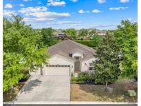 Beautiful single-story home featuring a three-car garage and a well-manicured lawn with mature trees at 5839 Tarleton Way, Mount Dora, FL 32757