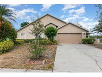 Charming single-Gathering home with a well-manicured lawn and a two-car garage in a suburban neighborhood at 6019 Long Peak Dr, Orlando, FL 32810