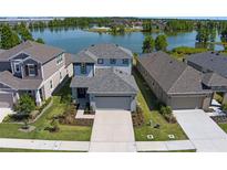 Stunning aerial view of home, showcasing its well-manicured lawn and waterfront location at 6728 Great Bear Dr, Lakeland, FL 33805