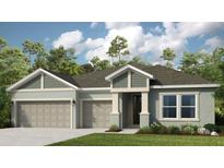 Charming single-Gathering home featuring a two-car garage, a well-manicured lawn, and lush landscaping at 861 Junonia Blvd, New Smyrna Beach, FL 32168