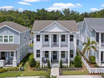 Charming two-story home featuring a double porch, columns, and landscaped yard at 908 Tilden Oaks Trl, Winter Garden, FL 34787