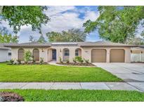 Charming home featuring a well-maintained lawn, a two car garage, and enhanced curb appeal at 1005 Turkey Hollow Cir, Winter Springs, FL 32708