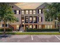 Attractive two-story townhome with a charming front porch and well-maintained landscaping at 1065 Clifton Springs Ln, Winter Springs, FL 32708