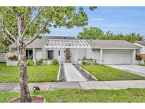 Charming single-story home with a well-manicured lawn and inviting walkway at 1218 Fairway Dr, Winter Park, FL 32792