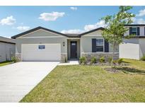 Charming one-story home with stone accents, a well-manicured lawn, and a two-car garage at 2141 Rosewood Dr, Bartow, FL 33830