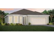 Charming single-story home with a symmetrical facade, a manicured lawn, and an attached two-car garage at 2745 Serenity Meadow Dr, Kissimmee, FL 34744