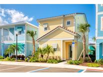 Charming colorful two-story home with manicured landscaping and accessible parking space at 2988 Salted Rim Rd, Kissimmee, FL 34747