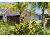 Garage exterior shows landscaping and hardscape at 3078 Isles Way, New Smyrna Beach, FL 32168