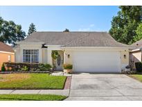 Charming one-story home featuring a manicured lawn and a two-car garage at 342 Hanging Moss Cir, Lake Mary, FL 32746