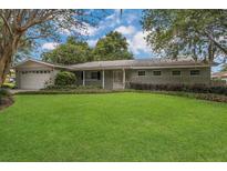 Charming single-story home with mature trees and a well-manicured lawn at 3605 Pershing Ave, Orlando, FL 32812