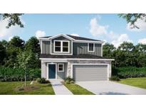 Two-story home with gray siding, stone accents, and a two-car garage, offering modern curb appeal at 3828 Bluethread Way, Poinciana, FL 34759