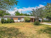 Charming single-story home with a well-maintained lawn and mature landscaping at 5811 Harcourt Ave, Orlando, FL 32839