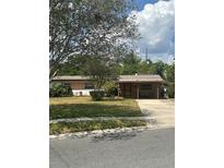 Charming single story home with mature landscaping and a brick facade at 5811 Harcourt Ave, Orlando, FL 32839