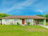 Charming single-story home with a well-manicured lawn and beautiful landscaping at 604 S Oxalis Ave, Orlando, FL 32807