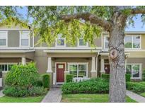 Charming townhome with well-manicured landscaping and welcoming front porch at 9112 Grey Moss Dr, Orlando, FL 32832